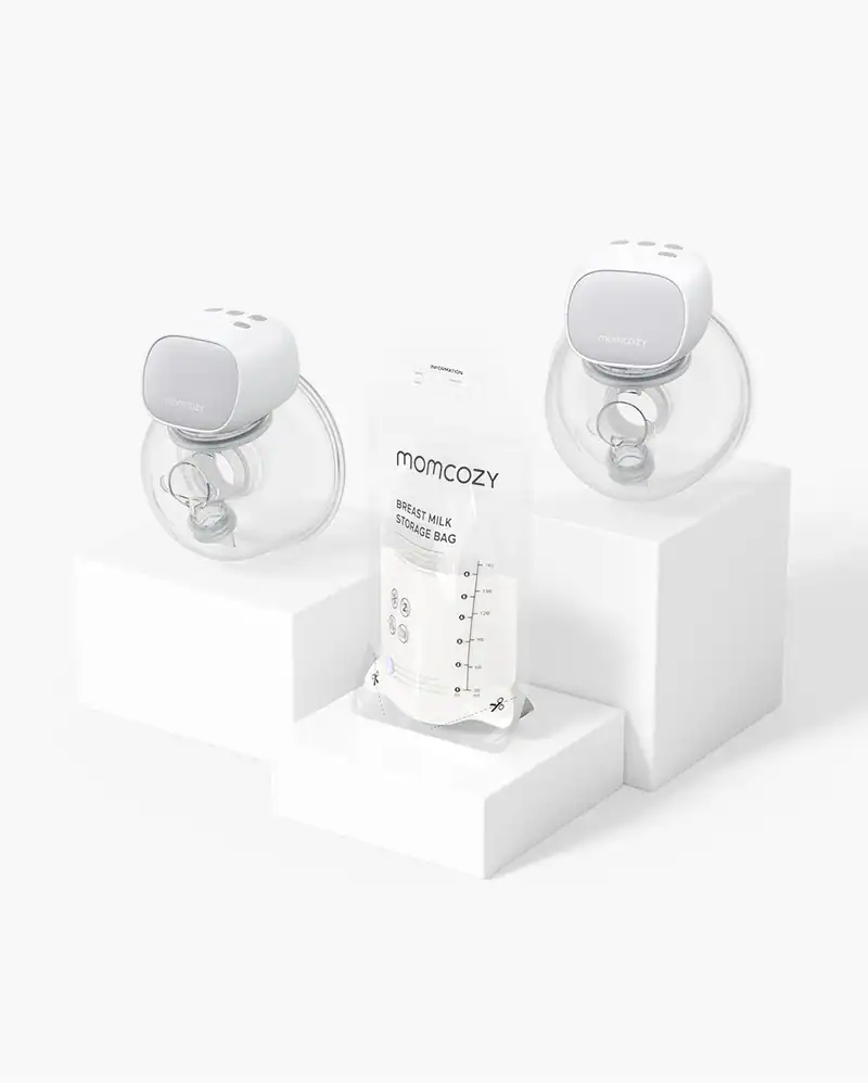 Two Momcozy wearable breast pumps and a Momcozy breast milk storage bag are displayed on white platforms against a white background.